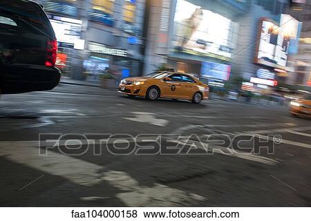 Taxi on city street at night View Large Photo Image Stock Photo - Taxi on city street at night. Fotosearch