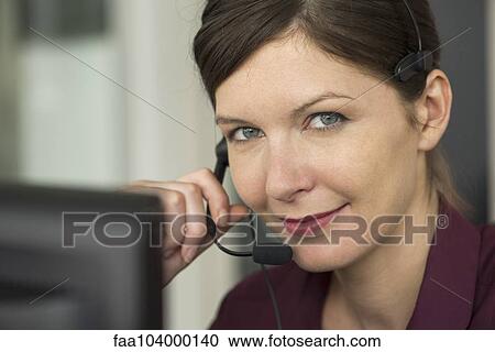 Stock Image - Telemarketer on phone call. Fotosearch