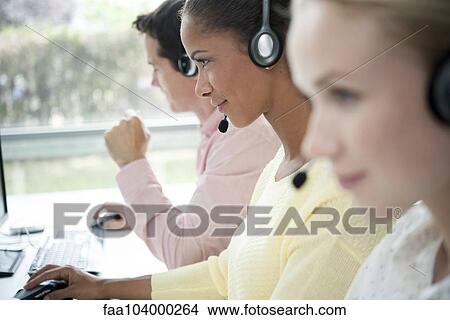Picture - Telemarketers at work in call center. Fotosearch