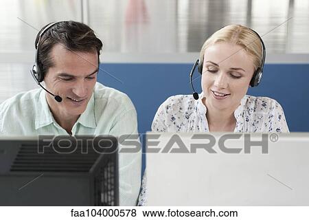 Telemarketers working in call center View Large Photo Image Stock Photo - Telemarketers working in call center. Fotosearch