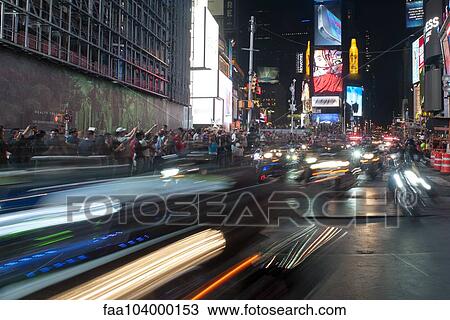 Stock Image - Tourists watching parade in Times Square at night, Manhattan, New York City, New York, USA. Fotosearch