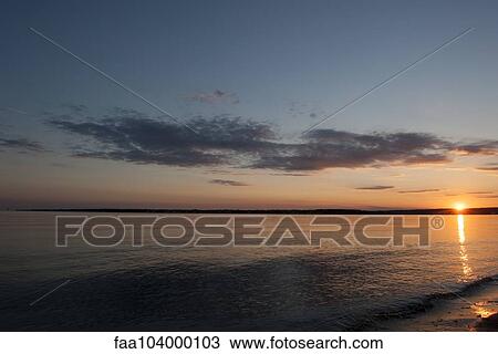 Stock Image - Tranquil beach sunset. Fotosearch