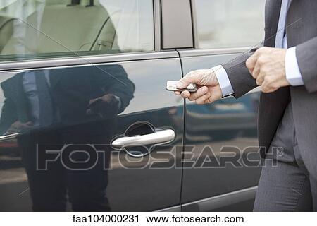 Unlocking car with remote control View Large Photo Image Stock Image - Unlocking car with remote control. Fotosearch