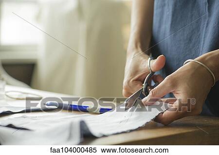 Woman cutting fabric, cropped View Large Photo Image Stock Photography - Woman cutting fabric, cropped. Fotosearch