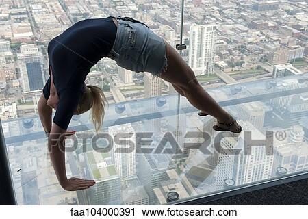 Woman doing backbend in glass-bottomed overservation deck at Willis Tower, Chicago, Illinois, USA View Large Photo Image Stock Image - Woman doing backbend in glass-bottomed overservation deck at Willis Tower, Chicago, Illinois, USA. Fotosearch