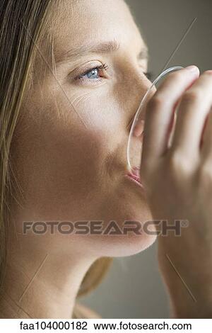 Stock Image - Woman drinking glass of water. Fotosearch
