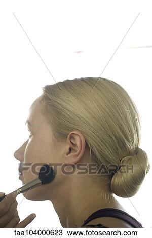 Woman having powder applied to face View Large Photo Image Stock Image - Woman having powder applied to face. Fotosearch