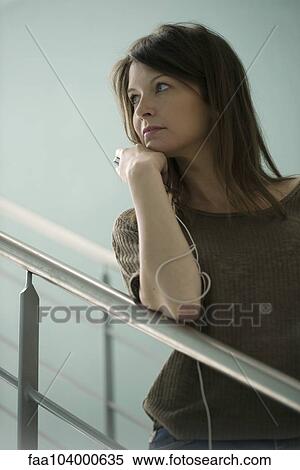 Stock Photography - Woman looking away with contemplative look. Fotosearch