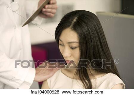 Stock Photo - Woman receiving bad news from doctor, cropped. Fotosearch