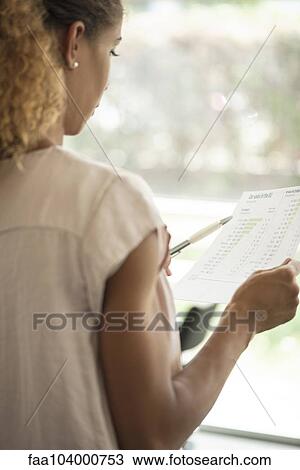 Woman reviewing document View Large Photo Image Stock Image - Woman reviewing document. Fotosearch