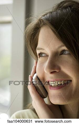 Stock Image - Woman using cell phone. Fotosearch