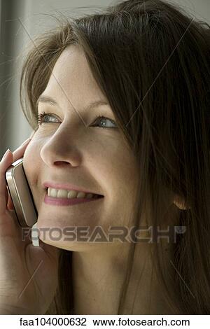 Stock Image - Woman using cell phone. Fotosearch