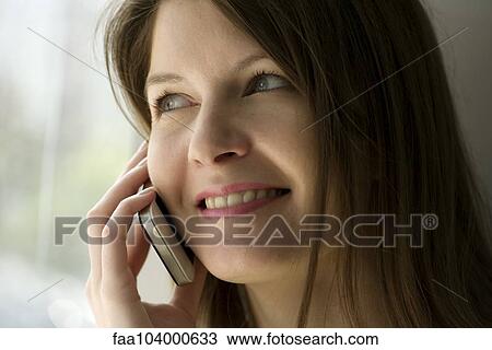 Stock Image - Woman using cell phone. Fotosearch