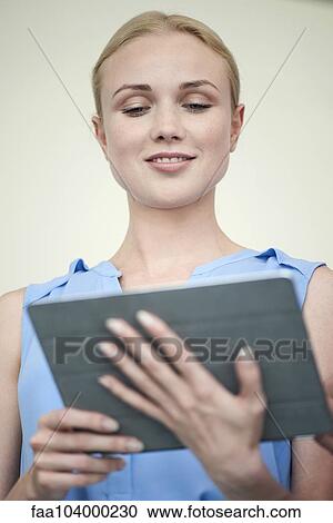 Stock Image - Woman using digital tablet. Fotosearch