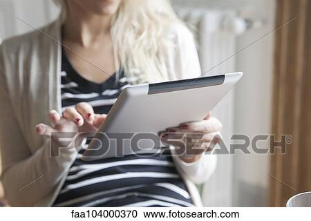 Woman using digital tablet View Large Photo Image Stock Image - Woman using digital tablet. Fotosearch