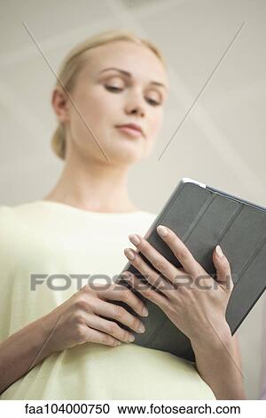 Woman using digital tablet View Large Photo Image Stock Image - Woman using digital tablet. Fotosearch