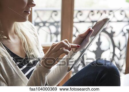 Stock Photo - Woman using digital tablet. Fotosearch