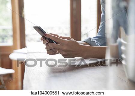 Stock Image - Woman using smartphone. Fotosearch
