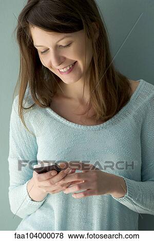 Woman using smartphone View Large Photo Image Stock Photo - Woman using smartphone. Fotosearch