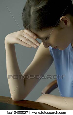 Stock Image - Woman with head lowered. Fotosearch