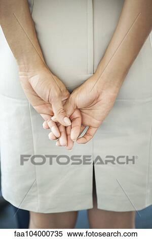 Stock Photography - Woman's clasped hands, rear view. Fotosearch