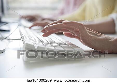 Woman's hands typing on a computer keyboard View Large Photo Image Stock Photo - Woman's hands typing on a computer keyboard. Fotosearch