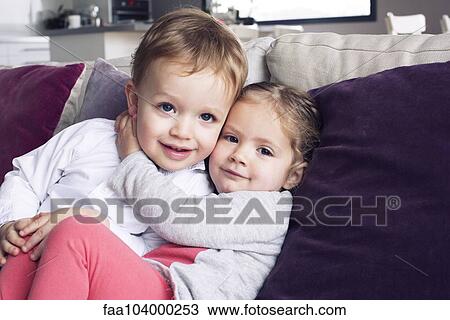 Young siblings embracing, portrait View Large Photo Image Stock Image - Young siblings embracing, portrait. Fotosearch