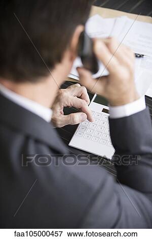 Accountant making phone call View Large Photo Image Stock Photo - Accountant making phone call. Fotosearch
