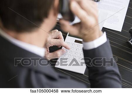 Stock Photo - Accountant reviewing financial accounts. Fotosearch