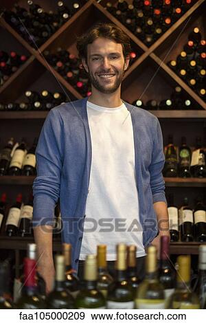 Stock Photo - Bartender in wine bar, portrait. Fotosearch