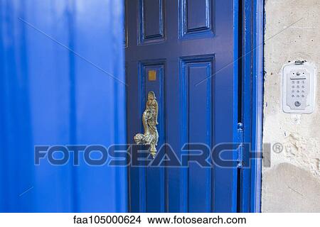 Picture - Blue door with brass handle. Fotosearch