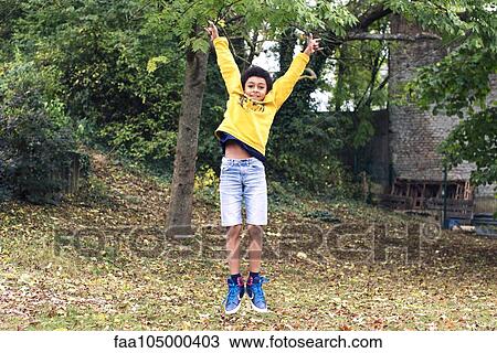 Boy jumping outdoors View Large Photo Image Stock Image - Boy jumping outdoors. Fotosearch