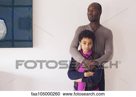 Boy leaning against father, portrait View Large Photo Image Stock Image - Boy leaning against father, portrait. Fotosearch