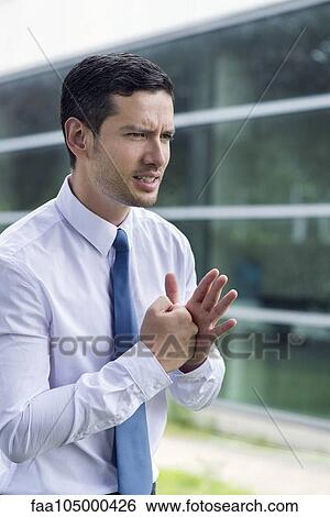 Stock Photograph - Businessman clenching fist in determination. Fotosearch