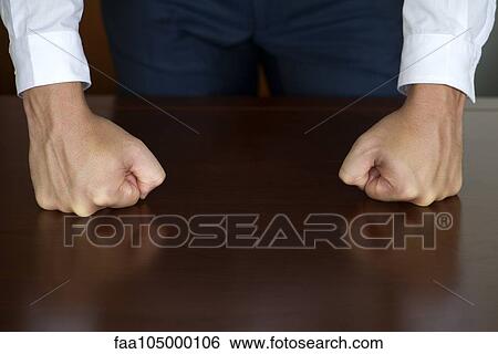 Stock Photograph - Businessman clenching fists, cropped. Fotosearch