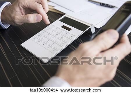 Businessman concerned about corporate finances making phone call View Large Photo Image Picture - Businessman concerned about corporate finances making phone call. Fotosearch