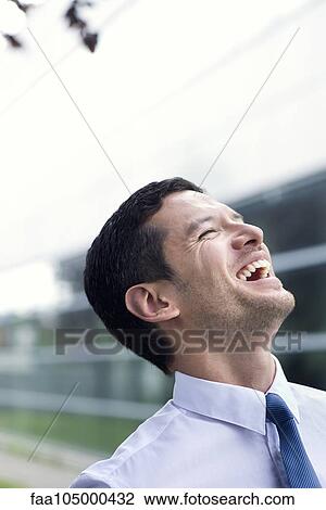 Businessman laughing outdoors View Large Photo Image Stock Image - Businessman laughing outdoors. Fotosearch