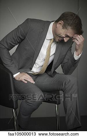 Businessman laughing with head down View Large Photo Image Stock Image - Businessman laughing with head down. Fotosearch
