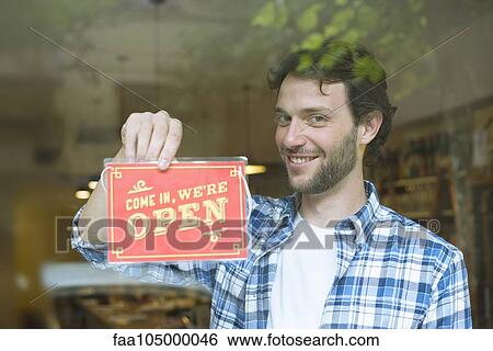 Businessman opening shop for business View Large Photo Image Stock Photograph - Businessman opening shop for business. Fotosearch
