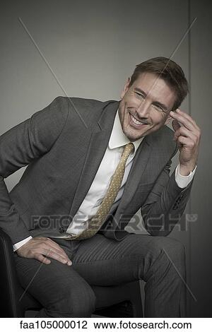 Stock Image - Businessman smiling cheerfully. Fotosearch