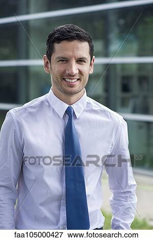 Stock Photo - Businessman smiling outdoors, portrait. Fotosearch