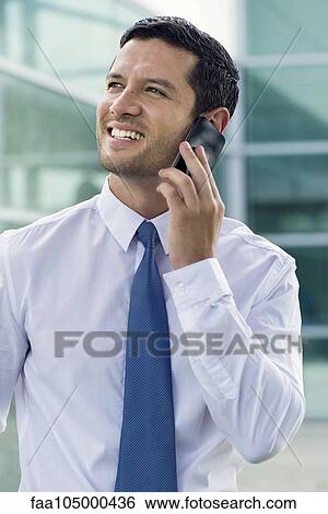 Businessman using cell phone, smiling View Large Photo Image Stock Photograph - Businessman using cell phone, smiling. Fotosearch