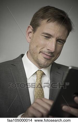Picture - Businessman using digital tablet. Fotosearch