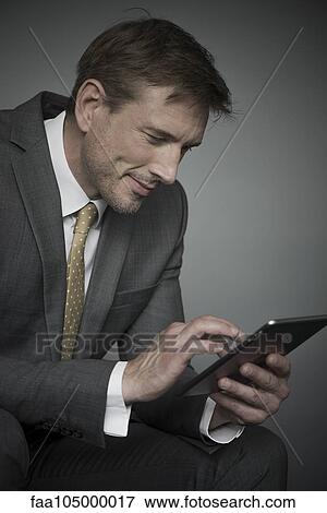 Stock Photo - Businessman using digital tablet. Fotosearch