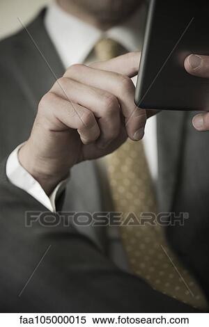 Businessman using wireless device, cropped View Large Photo Image Stock Photography - Businessman using wireless device, cropped. Fotosearch