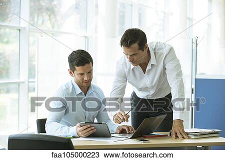 Businessmen working together View Large Photo Image Stock Image - Businessmen working together. Fotosearch
