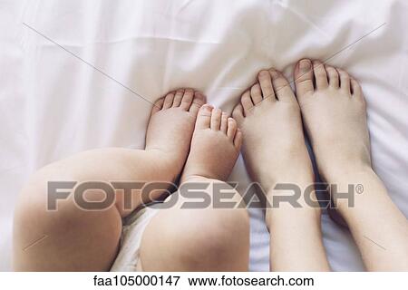 Child and baby's bare feet View Large Photo Image Stock Photo - Child and baby's bare feet. Fotosearch