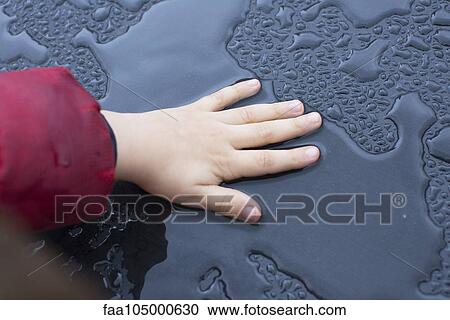 Child touching wet metallic surface View Large Photo Image Stock Image - Child touching wet metallic surface. Fotosearch
