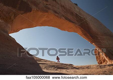 Child walking under natural arch in Utah, USA View Large Photo Image Stock Photo - Child walking under natural arch in Utah, USA. Fotosearch