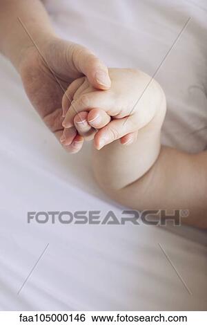Child's hand holding baby's hand View Large Photo Image Stock Photograph - Child's hand holding baby's hand. Fotosearch